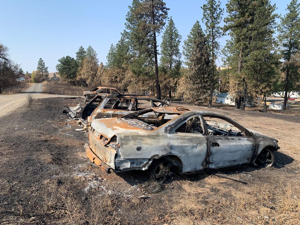 Burned cars from a wildfire that destroyed most of the eastern Washington town of Malden on Labor Day.