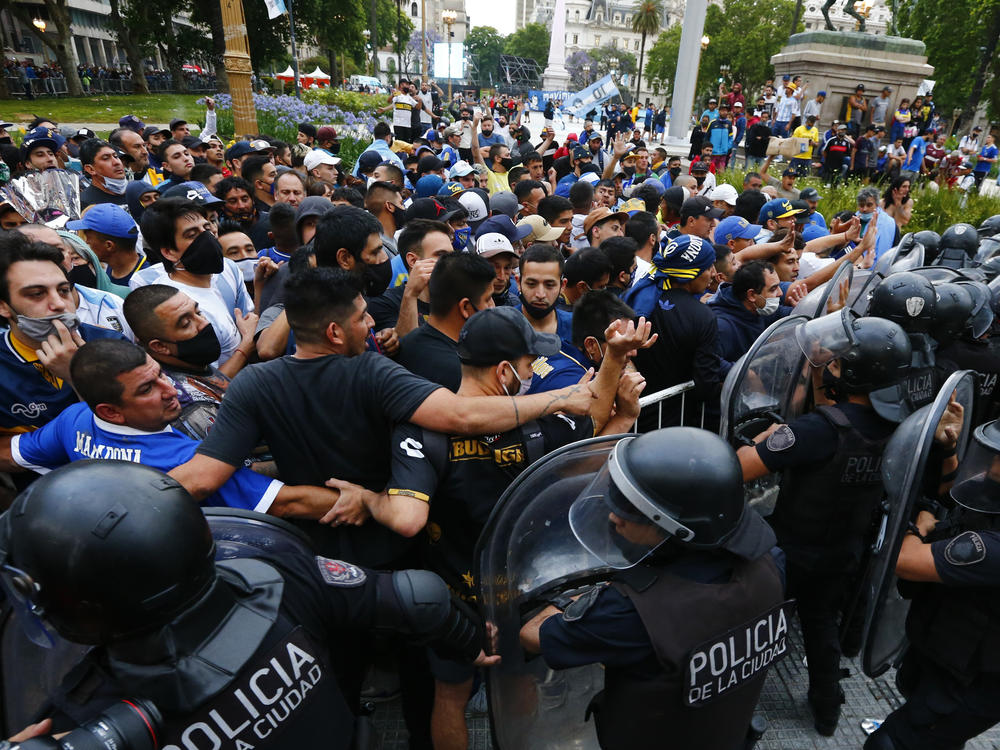Police block soccer fans waiting to see Diego Maradona lying in state in Buenos Aires on Thursday.