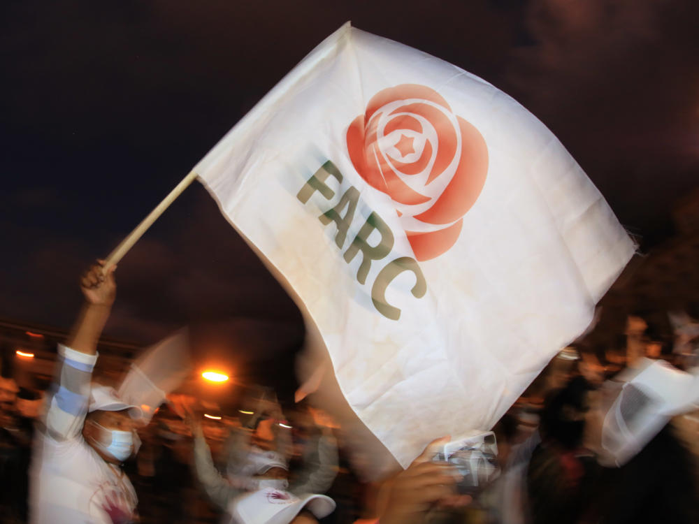 A former FARC guerrilla member waves a FARC political party flag during a demonstration in Bogota on Nov. 2. A federal court overturned an asylum decision Wednesday, holding that FARC death threats counted as persecution.×