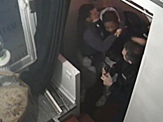 This video grab taken on Thursday from an AFP video shows CCTV camera footage, widely distributed on social networks, shows producer Michel Zecler being beaten up by police officers at the entrance of a music studio in the 17th arrondissement of Paris on Nov. 21.