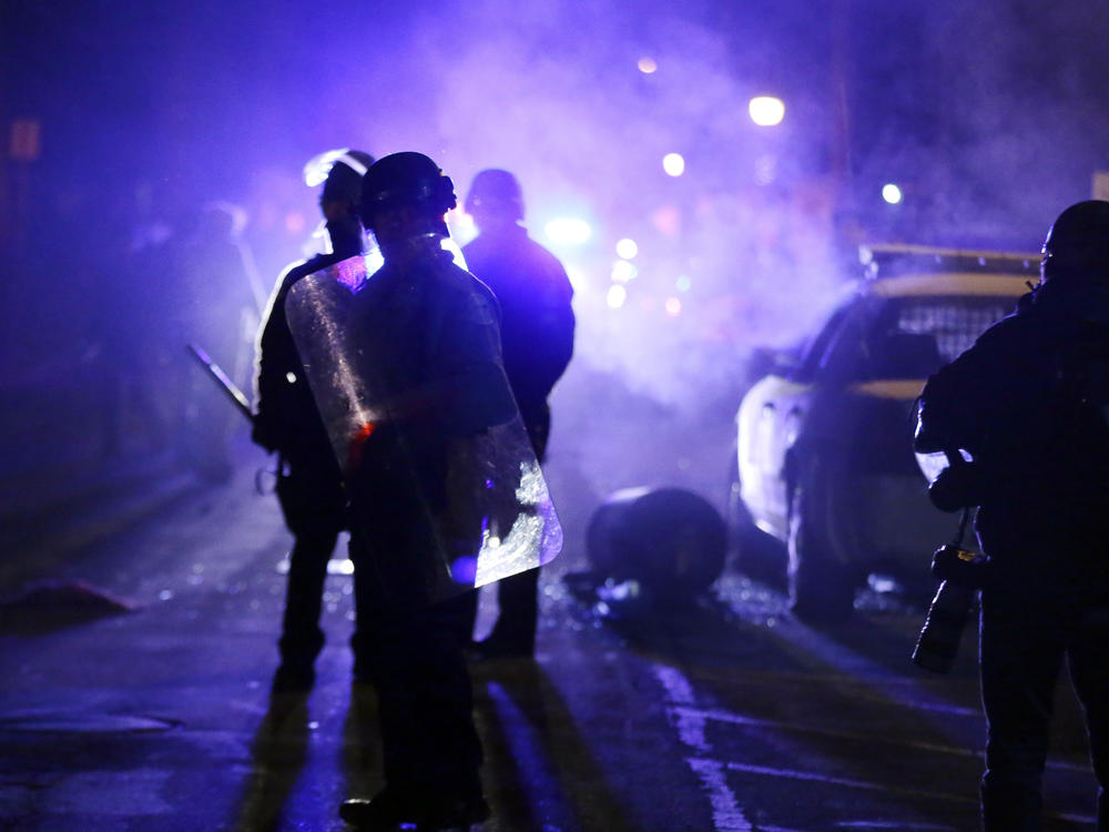 Police officers in Ferguson, Mo., during a protest in 2014. Advocates want the Justice Department to step up its oversight of law enforcement in the incoming administration.