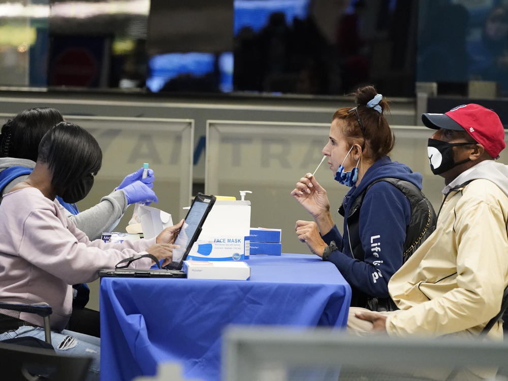 Travelers self-test for the coronavirus at a mobile testing site at New York City's Penn Station in the days leading up to Thanksgiving. The U.S. is currently seeing record hospitalizations for COVID-19, and health experts fear more surges are on their way.