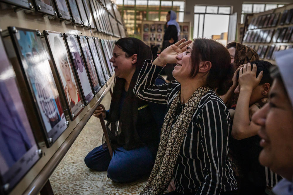 Women from Kocho village mourn family members who were among the 3,000 Yazidis killed by ISIS during a 2019 commemoration of the fifth anniversary of the start of the ISIS genocide against Yazidis. ISIS fighters shot more than 500 men and older boys in the small village.
