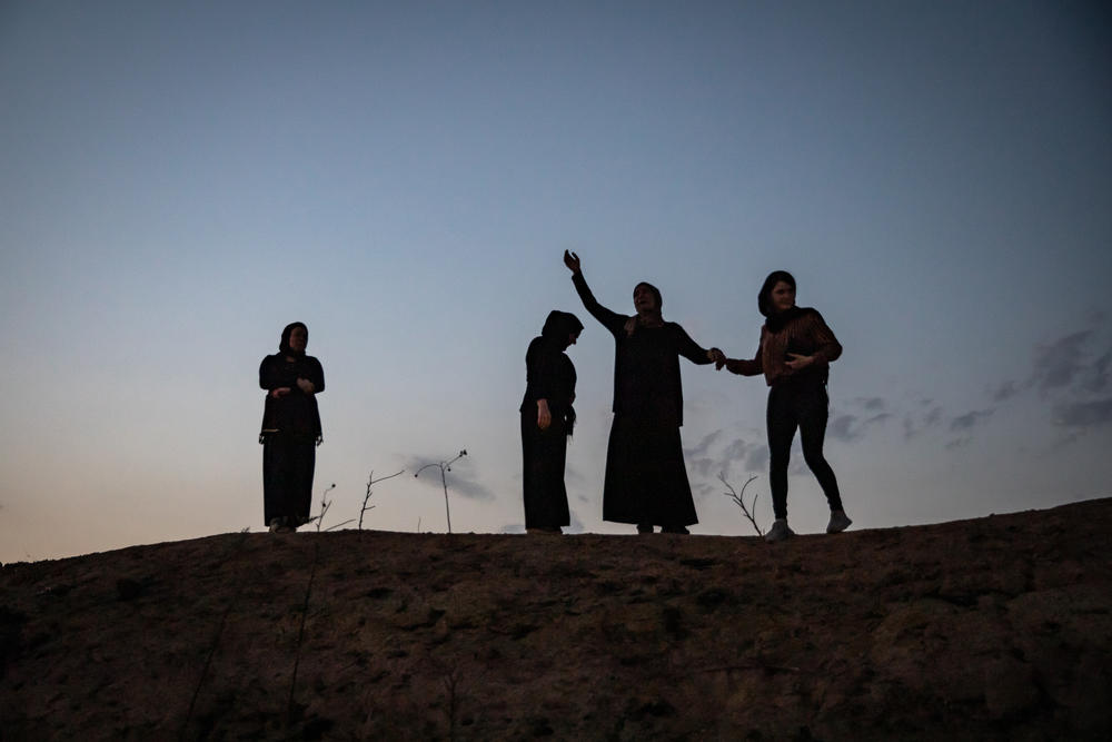 Former residents of the Yazidi village of Kocho, northern Iraq, mourn at the locations of mass graves where their family members were killed by ISIS.
