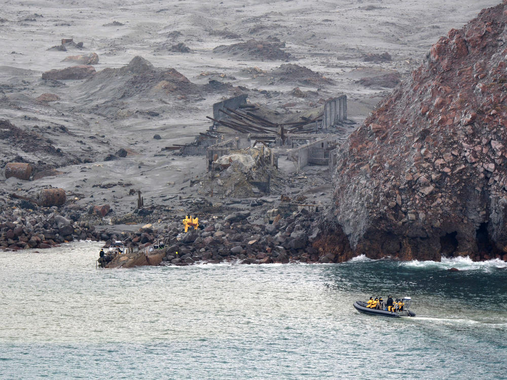 Recovery workers are seen at New Zealand's White Island last December. A volcanic eruption on the island killed 22 people and has led to work safety charges against tour operators.
