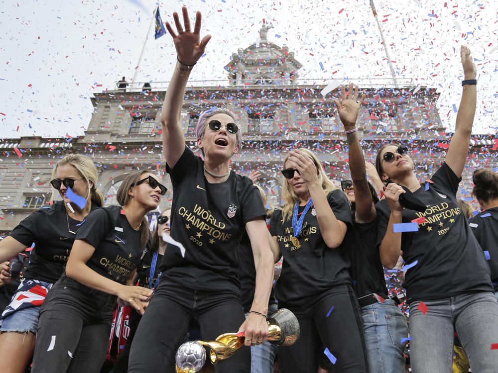 Megan Rapinoe (center) and Alex Morgan (right), pictured celebrating with U.S. women's soccer teammates in New York after a ticker tape parade, on July 10, 2019. 