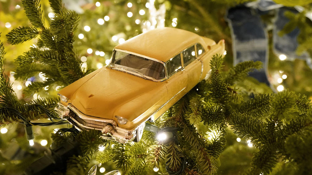 A toy car hangs in a Christmas tree in the East Room of the White House during the 2020 Christmas preview, Monday, Nov. 30, 2020, in Washington. (AP Photo/Patrick Semansky)