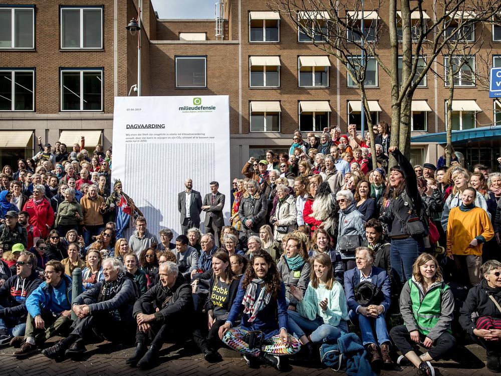 Activists march to Shell's headquarters in The Hague, Netherlands, in April 2019, delivering a legal summons to the company. The civil case began Tuesday, with plaintiffs demanding the company reduce its carbon dioxide emissions.