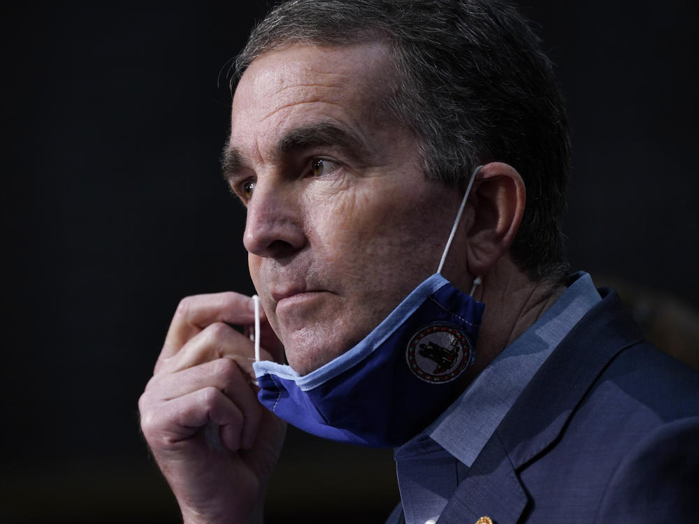 Virginia's Campbell County is pushing back on Gov. Ralph Northam's coronavirus restrictions, saying they violate individual rights. Here, Northam removes his mask during a COVID-19 briefing last month in Richmond.