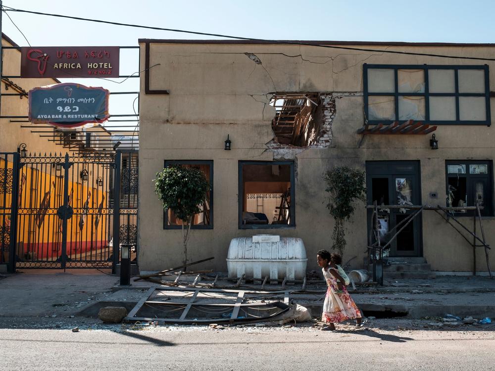 A child plays in front of a hotel damaged by mortar shelling last month in Humera, in the Tigray region of Ethiopia. On Wednesday, U.N. officials announced they had reached a deal with Ethiopian leaders to allow humanitarian groups access to the disputed region.