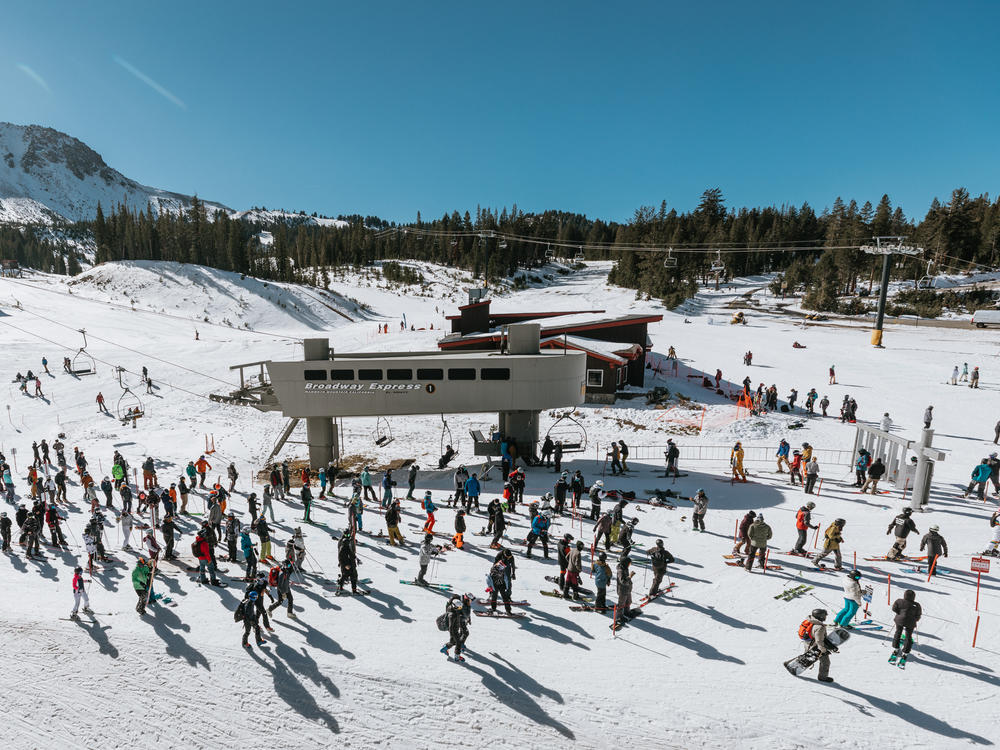 Skiers and snowboarders wait in a socially distanced lift line at Mammoth Mountain on Nov. 15.