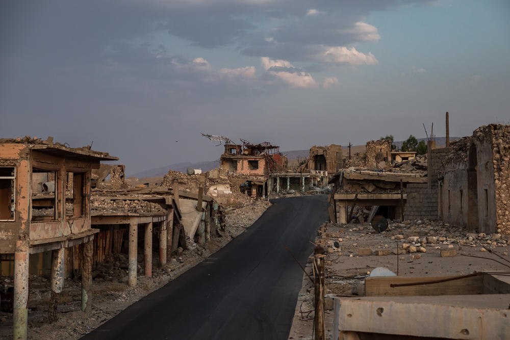A newly paved road has been one of the only repairs done to the heavily damaged market area of the city of Sinjar, northern Iraq, after it was liberated by U.S.-backed Kurdish forces in 2015. Almost nothing has changed in the damaged old part of Sinjar since this photo was taken in 2019.