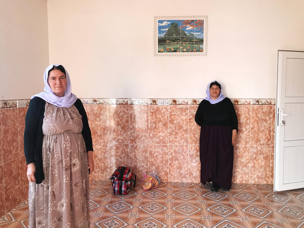 Nofa Khudeda (left) and a neighbor in the village of Tel Qasab on the day Khudeda and her husband returned after six years in a camp for displaced Yazidis. Khudeda and her husband, Ali Edo, repaired and renovated the house, which had been looted by ISIS fighters and then militias that fought ISIS.