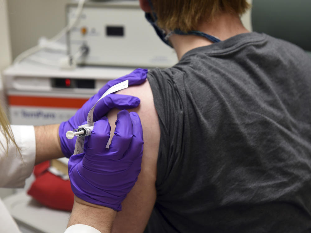 This photo provided by the University of Maryland School of Medicine shows the first patient enrolled in Pfizer's COVID-19 coronavirus vaccine clinical trial receiving an injection in May.