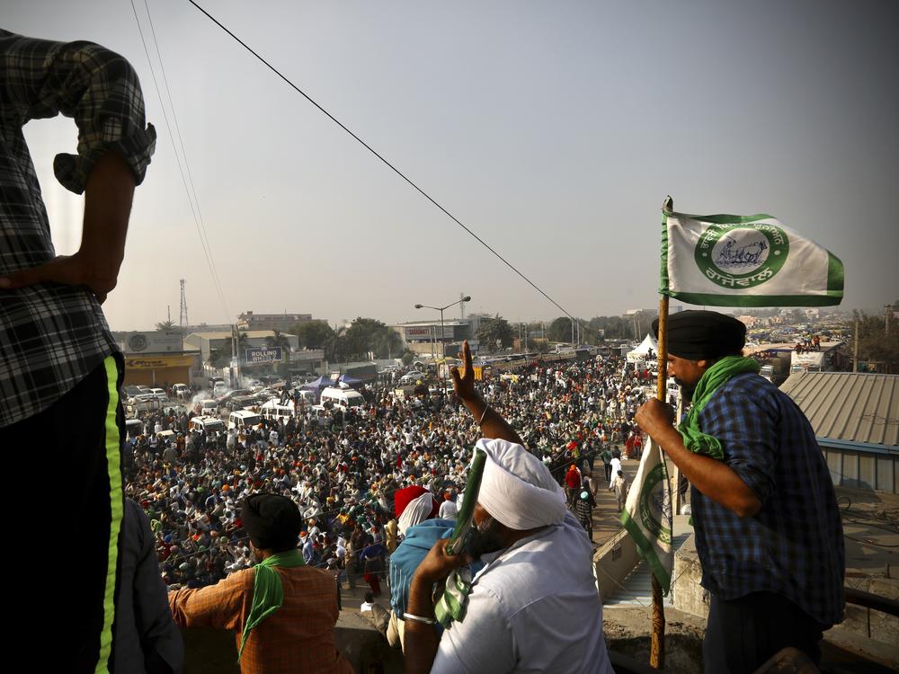 Farmers protest Thursday on a highway at the Delhi-Haryana state border in India. They have descended upon the borders of New Delhi to protest new farming laws that they say will open them to corporate exploitation.