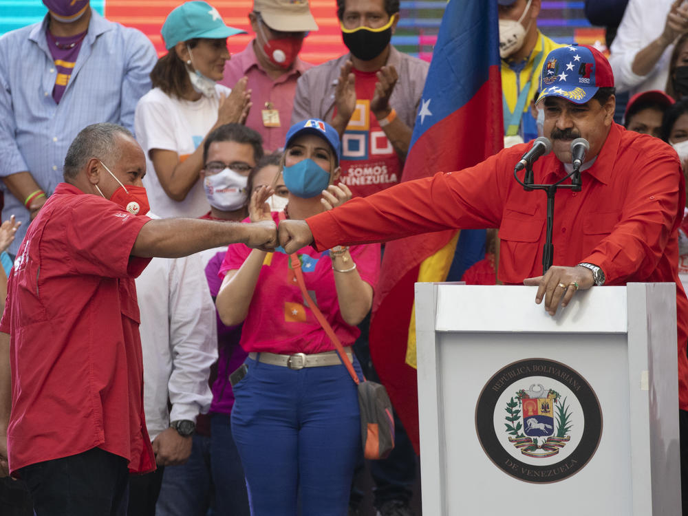 Diosdado Cabello (left), a candidate in Venezuela's upcoming National Assembly elections, bumps fists with Venezuelan President Nicolás Maduro during a closing campaign rally in Caracas, Venezuela, on Thursday. Venezuelans will vote for a new National Assembly on Sunday.