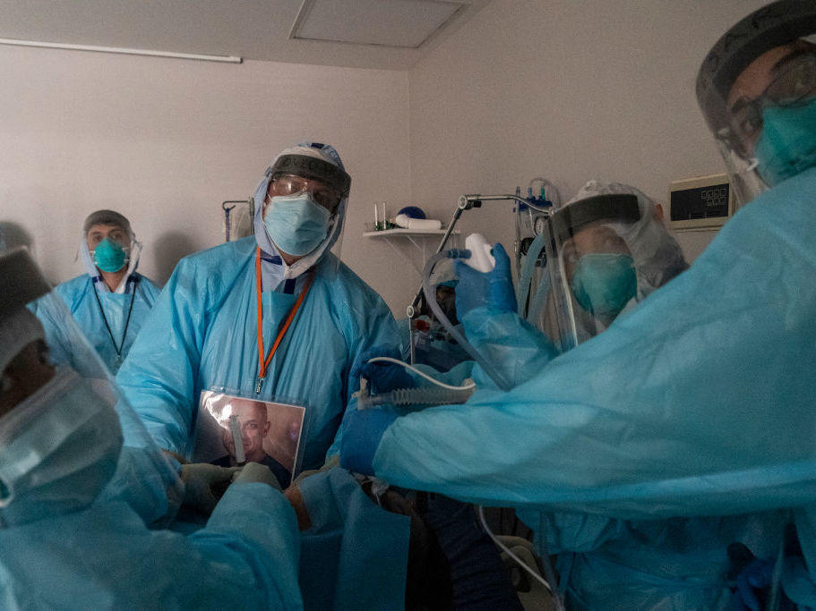 Health care workers in Houston, Texas, perform a procedure on a patient in the COVID-19 intensive care unit on Thanksgiving. This past week has seen continued steep growth in cases, hospitalizations and deaths from COVID-19.