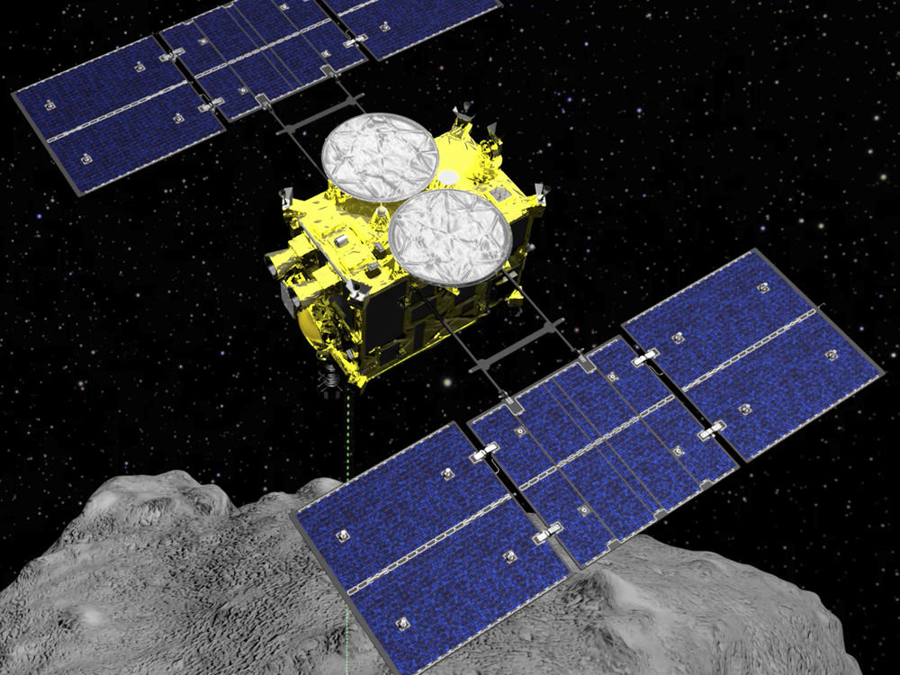 This computer-generated image shows the Hayabusa2 spacecraft above the asteroid Ryugu. This weekend, the sample collected by the spacecraft arrived on Earth after a six-year mission.