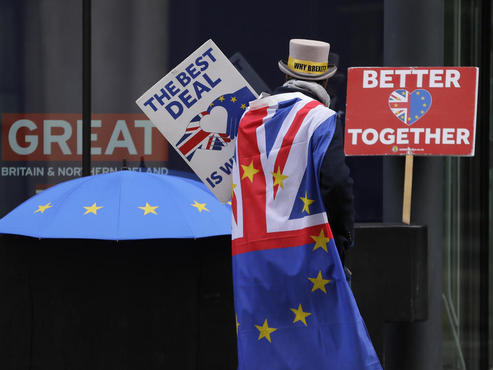 A pro-EU demonstrator sets up banners outside a London conference center, where trade talks were being held on Dec. 4.