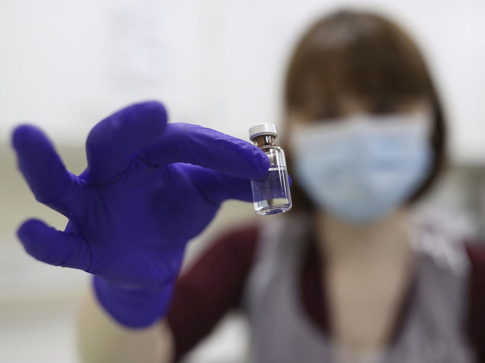 A National Health Service pharmacy technician at the Royal Free Hospital in London simulates the preparation of the Pfizer vaccine Friday for support staff training ahead of this week's rollout.