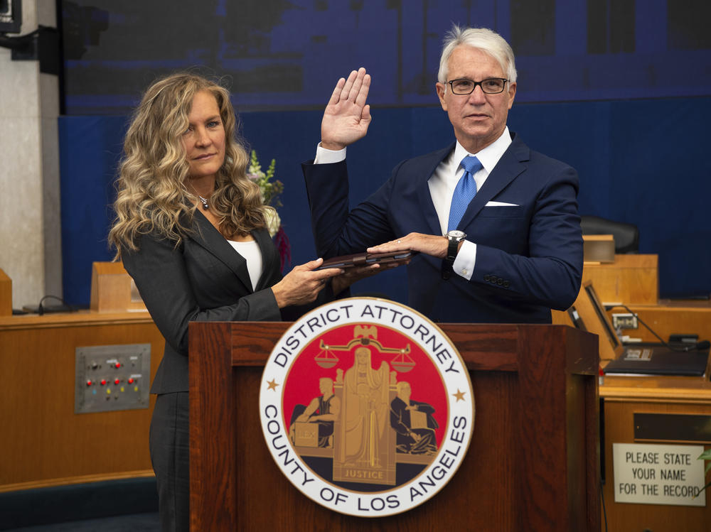 Los Angeles County District Attorney George Gascón is sworn in accompanied, by his wife Fabiola Kramsky. During his inaugural speech, he unveiled a series of criminal justice reforms that impact how prosecutors in his office pursue convictions, sentencing and cash bail.