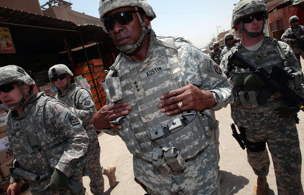 U.S. Army Lt. Gen. Lloyd Austin (center) and members of his entourage tour the Jamila market in Baghdad, Iraq, in 2008. To become defense secretary, Austin will need a waiver from Congress since he has not been out of uniform for the required seven years. He retired from the military in 2016.