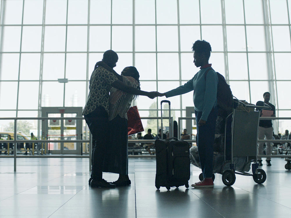 After a 17-year separation, Walter (Ntare Guma Mbaho Mwine) greets his wife Esther (Zainab Jah) and daughter Sylvia (Ekwa Msangi) at JFK airport in the opening scene of <em>Farewell Amor. </em>