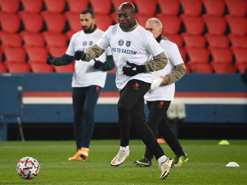 Istanbul Basaksehir assistant coach Pierre Webo, along with players on both Basaksehir and Paris Saint-Germain, wore T-shirts during warmup Wednesday that said 