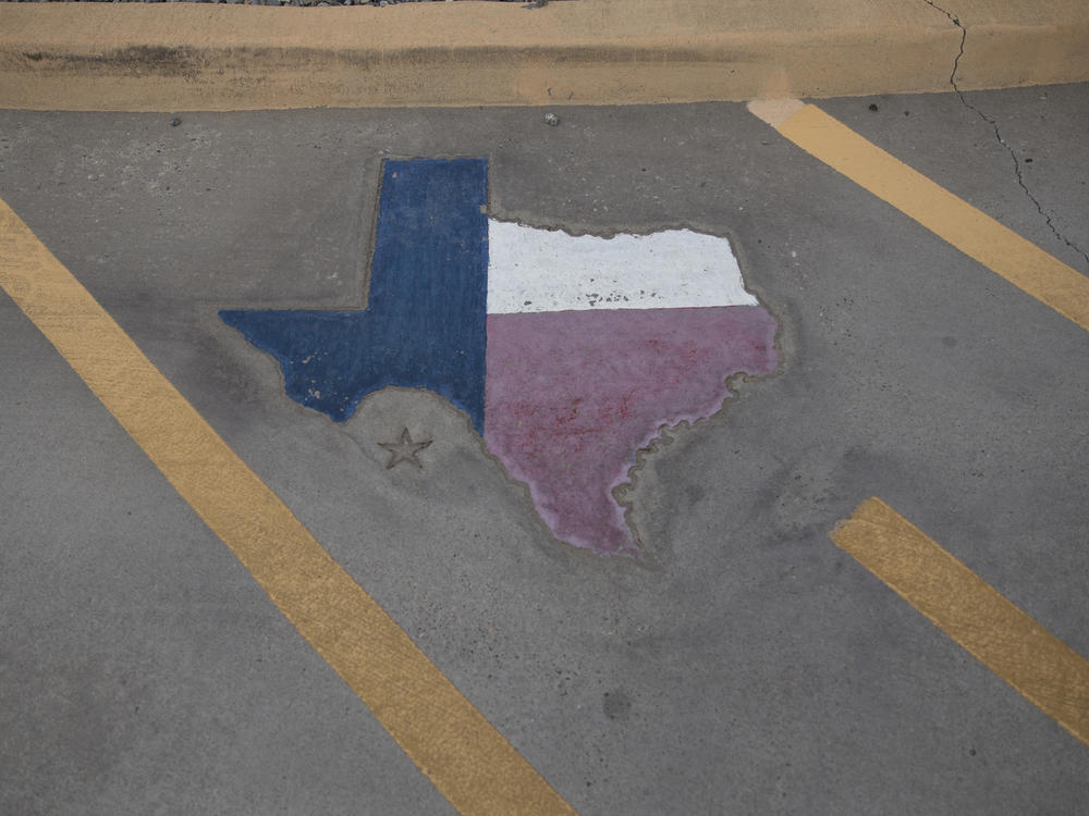 A map of Texas is displayed on a parking spot at the Old Glory Memorial in El Paso, Texas, last year.