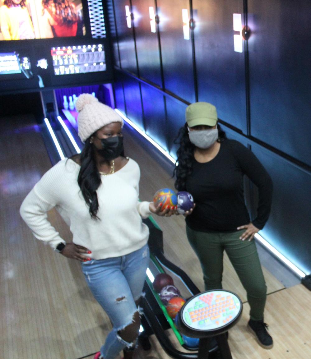 Sharise Crumley of Southfield, Mich., and Linnea Nelson of Oakpark, Mich., hold Lucky Strike's sized-down bowling balls. They weigh about 3 to 4 pounds and don't have any holes.