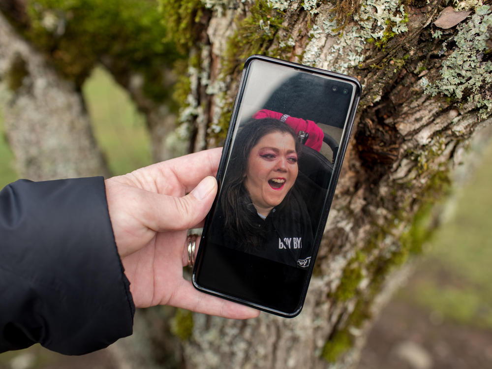 Kimberly Conger, Sarah McSweeney's nurse at her group home, shows a photo of McSweeney on her phone. She says McSweeney was outgoing and fun: 