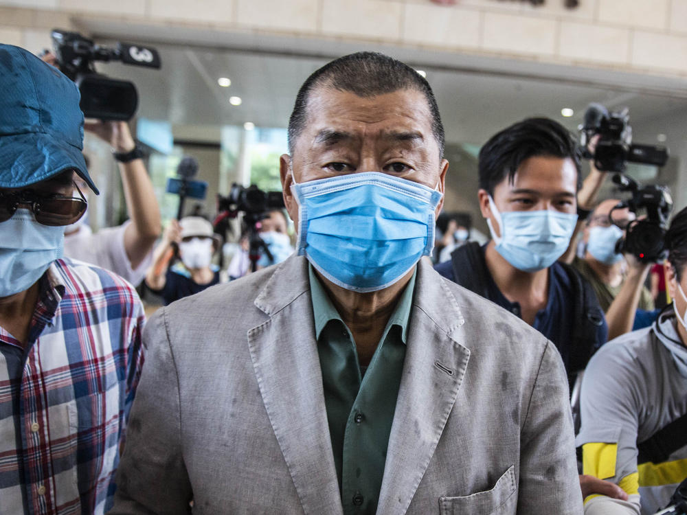 Hong Kong media mogul Jimmy Lai, seen here before a court hearing in September, has been formally charged under China's controversial new national security law.