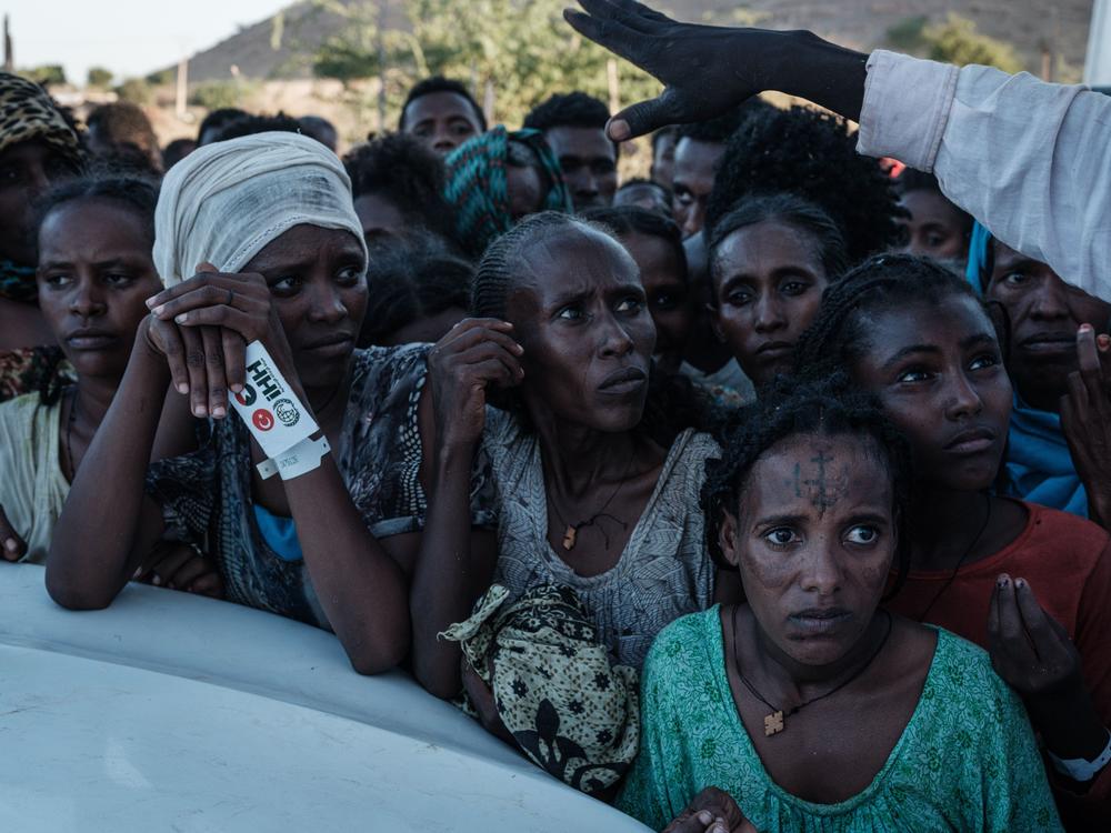 Ethiopians wait for food distribution in front of a warehouse at Um Raquba refugee camp in Gedaref, eastern Sudan, on Dec. 1.