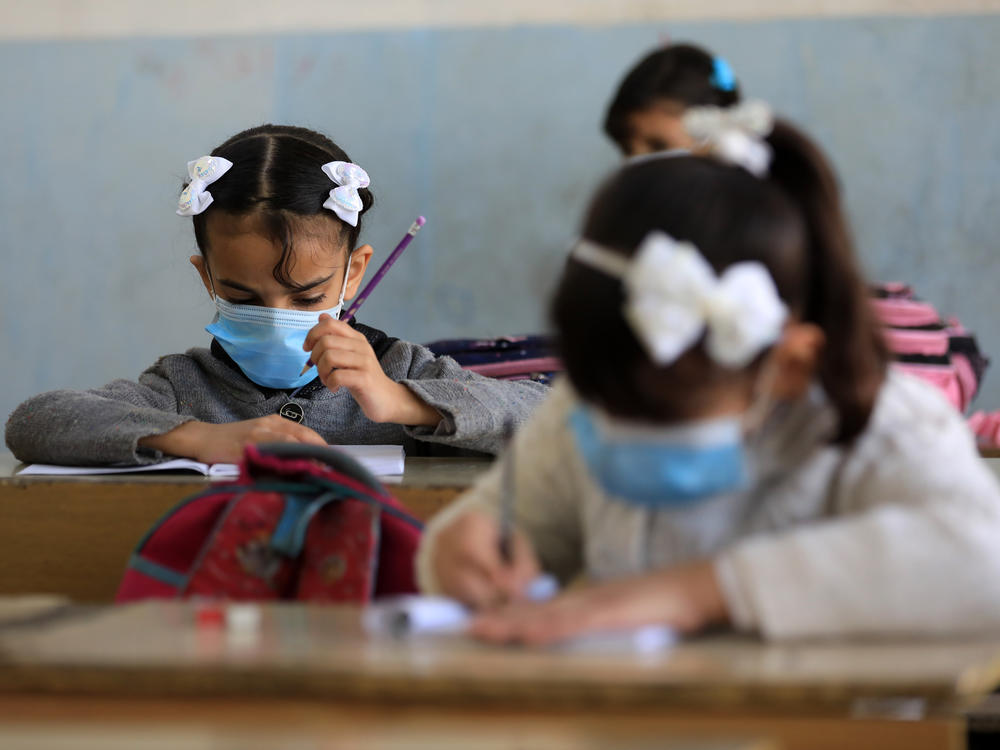 Students wear masks at a school in Baghdad.