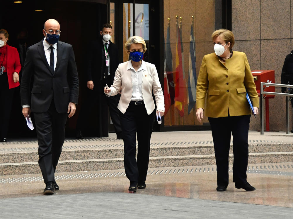 Charles Michel, president of the European Council (left); Ursula von der Leyen, president of the European Commission (center); and Angela Merkel, Germany's chancellor, wear protective face masks as they walk to a news conference at a European Union leaders summit Friday in Brussels.