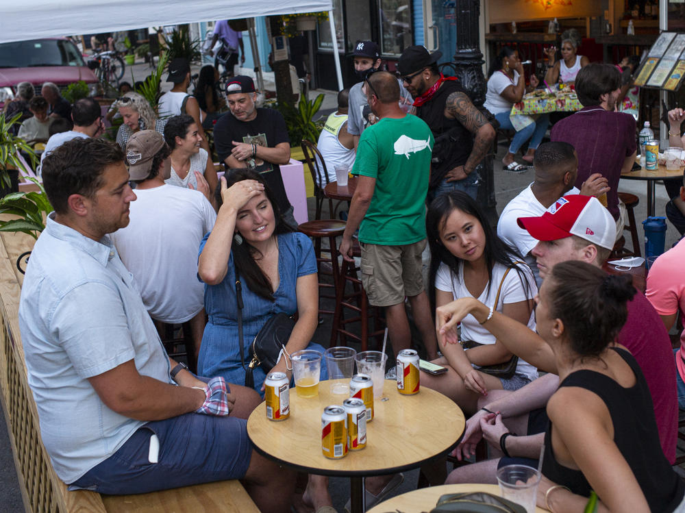 Over the summer in New York City, customers could patronize restaurants by using outdoor sidewalk seating. Physical distancing and masks were encouraged, but at this Brooklyn restaurant in July, few stayed far apart or wore a mask.