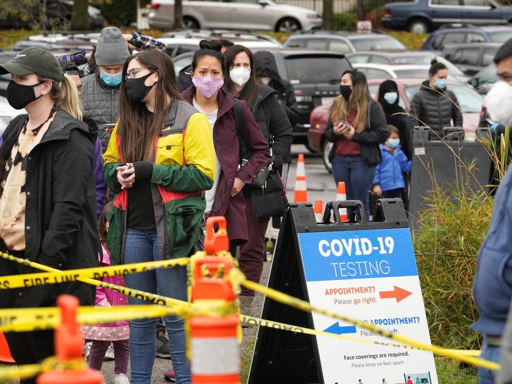 People line up to be tested for the coronavirus at a free testing site Wednesday, Nov. 18 in Seattle.