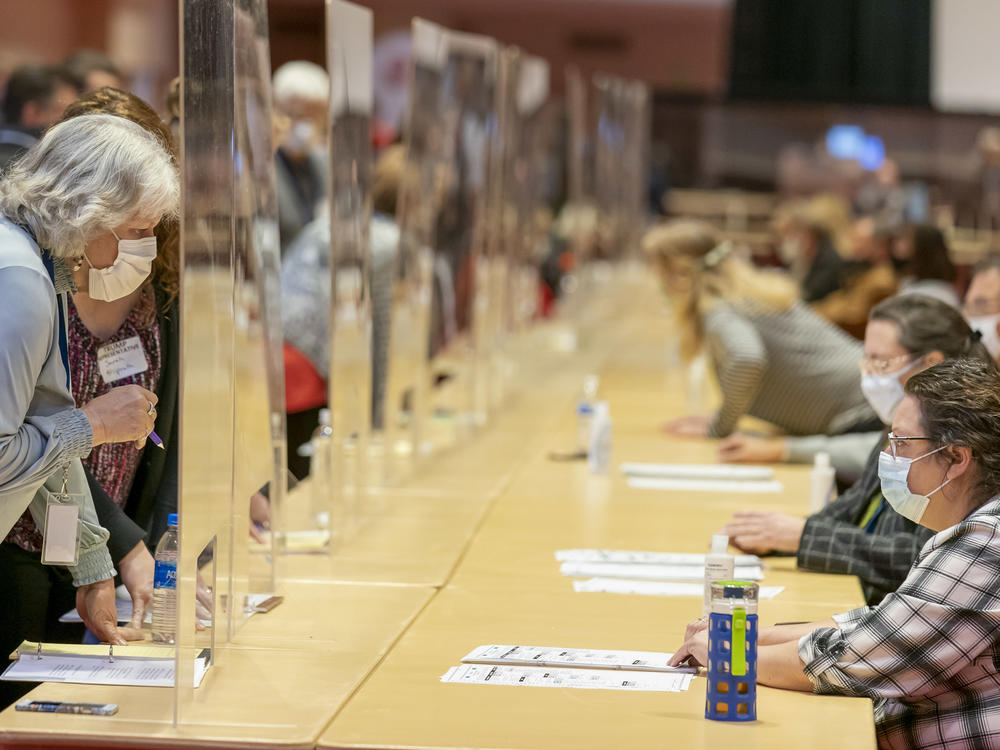 Representatives for President Trump (left) review ballots Nov. 20 in Madison, Wis., during the recount vote in Dane County. A state judge on Friday rejected a Trump campaign attempt to challenge the voting process in Dane and Milwaukee counties.