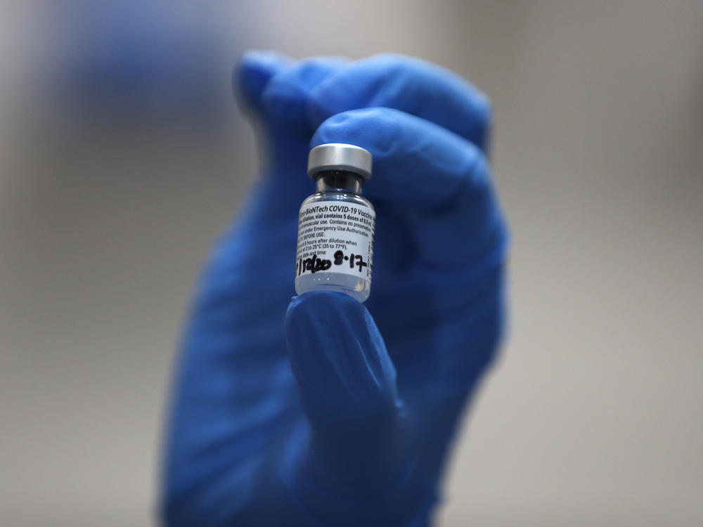 A nurse holds a vial of the COVID-19 vaccine produced by Pfizer and BioNTech, in London earlier this week. Food and Drug Administration officials in the U.S. sought to reassure the public about the vaccine Saturday after authorizing it for emergency use.