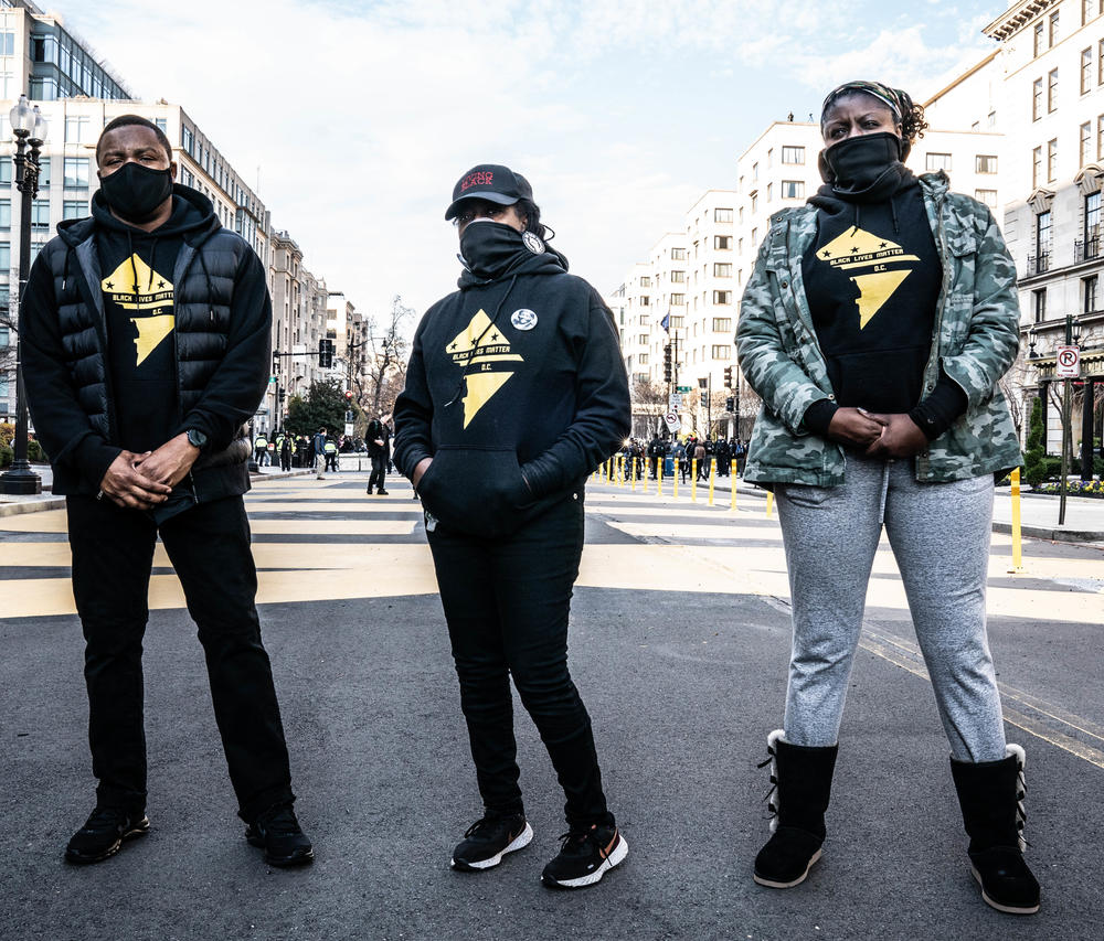 Members of Black Lives Matter, Anthony Lorenzo Green (from left), Nee Nee and Qiana Johnson, stand at Black Lives Matter Plaza.