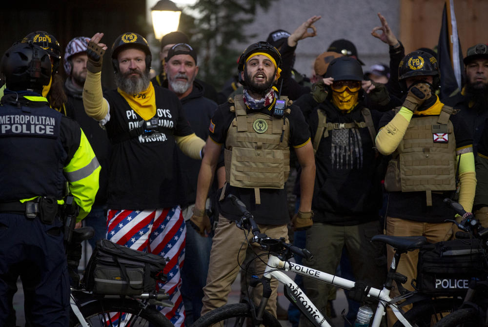 Proud Boys scream at counterprotesters near McPherson Square. Police separated the two groups.