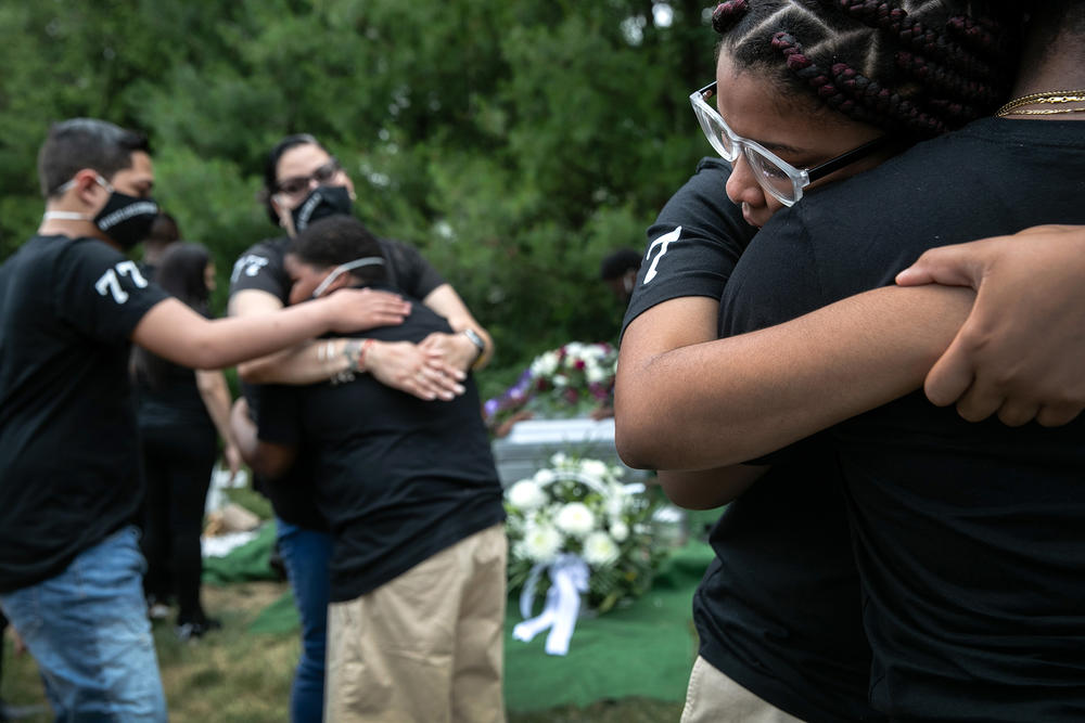 Family members mourn the death of Conrad Coleman Jr. at his burial on July 3 in Rye, N.Y. Coleman, 39, died of COVID-19 on June 20, just over two months after his father, Conrad Coleman Sr., also died of the disease.