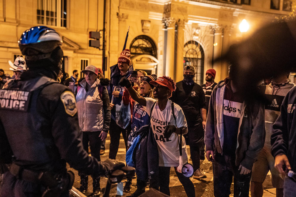 Trump supporters argue with counterprotesters, expressing that Trump will have four more years as president.