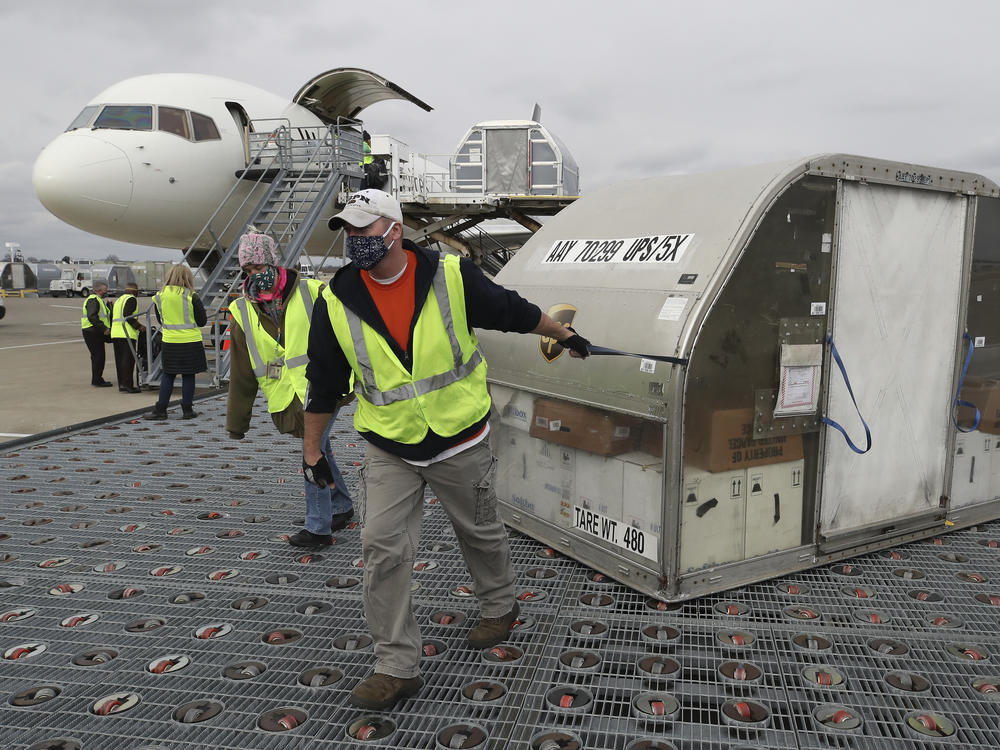 Two shipping containers holding the first doses of the Pfizer and BioNTech COVID-19 vaccine arrived at the UPS Worldport in Louisville, Ky., on Sunday.