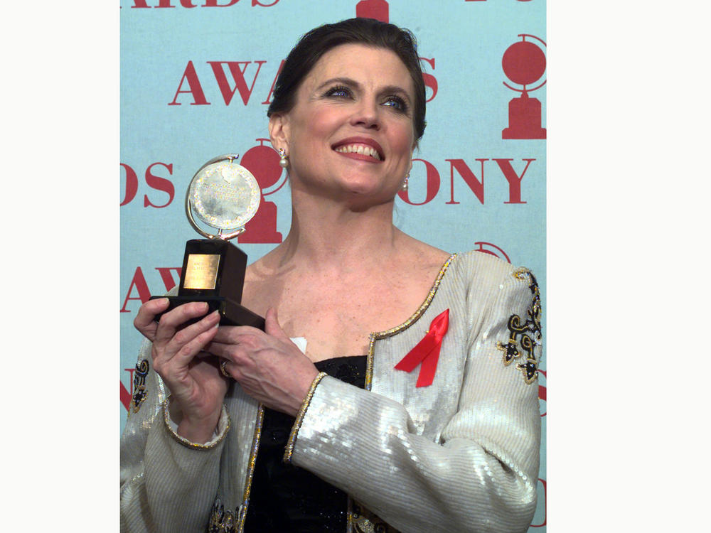 Ann Reinking, pictured holding her Tony Award for best choreography for the musical <em>Chicago</em> in 1997, died on Saturday, her family said in a statement.