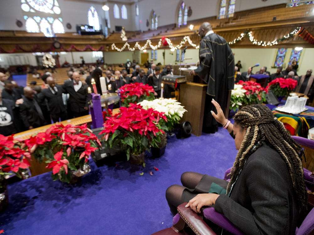 Pastor Rev. William Lamar IV leads his congregation in prayers, during a service at the Metropolitan AME Church in Washington, D.C., in 2014.