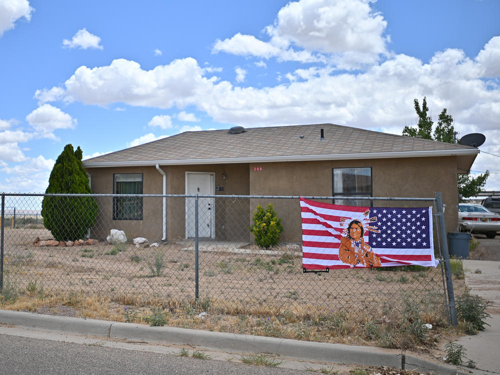 An American flag with an image of a Native American on it in To'Hajiilee Indian Reservation in New Mexico. In California, a vaccine allocation committee is considering taking historical injustice into account in advance of a statewide rollout.