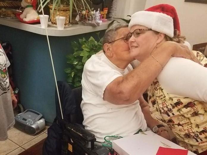A resident of the Cordell Christian Home in Cordell, Okla., kisses Mrs. Claus at the annual holiday party in 2017.