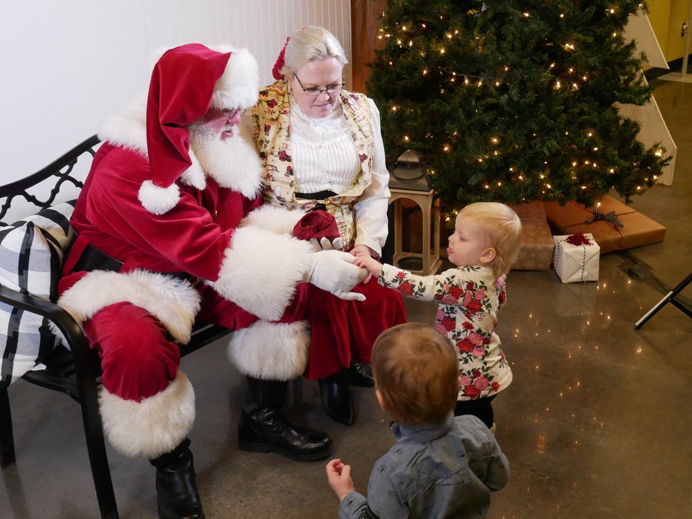 Keith and Melanie Hubbard, who portray Santa and Mrs. Claus in Oklahoma greet their grandchildren in 2019.