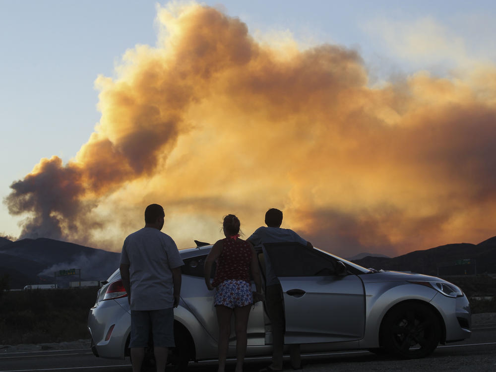People watch the Blue Cut Fire in Lytle Creek, Calif., in 2016.